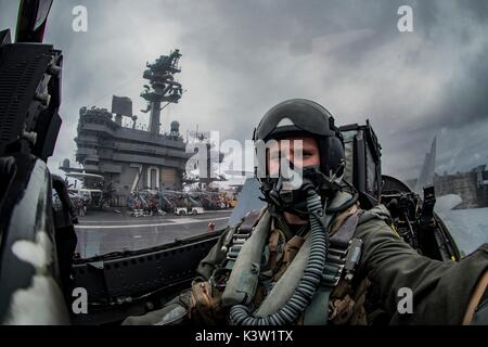 Un U.S. Navy F/A-18F Super Hornet jet fighter aircraft terre pilota sul ponte di volo a bordo della U.S. Nimitz Navy-class portaerei USS Carl Vinson Febbraio 15, 2017 nel Mare delle Filippine. (Foto di MCS2 Z.A. Landers via Planetpix) Foto Stock