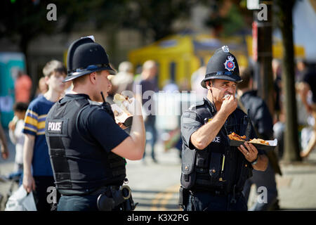 Lavorando in uniforme dei poliziotti di mangiare a Bolton Alimentari e Drink Festival Lancashire Foto Stock