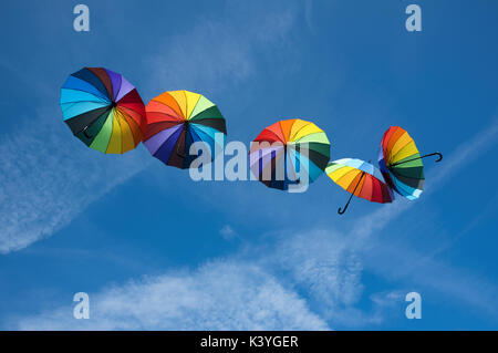 Ombrelloni colorati fluttuante nel cielo blu Foto Stock