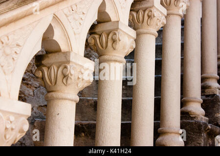 Dettagli architettonici di un edificio in pietra nella vecchia città del Mediterraneo Sibenik, Croazia: ringhiere intagliate colonne sulla scaletta Foto Stock