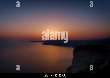 Moody tramonto sul mare con una vista su ripide scogliere in Corsica vicino a Bonifacio Foto Stock