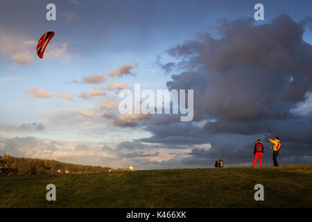 Due londinesi volare i loro kite su un ventoso, tempestosa, giornata di sole su Hampstead Heath Foto Stock
