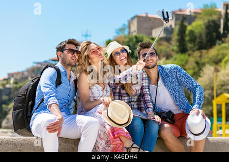 Gruppo di amici facendo ritratti divertenti per esterno Foto Stock