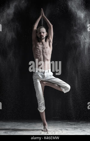 Ritratto di giovane caucasico uomo bianco che indossa pantaloni sportivi  fare yoga o pilates esercizio Foto stock - Alamy
