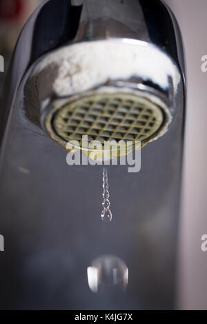 Il vecchio perde il rubinetto con pietra e sedimenti di calcio a causa di acqua dura. Foto Stock