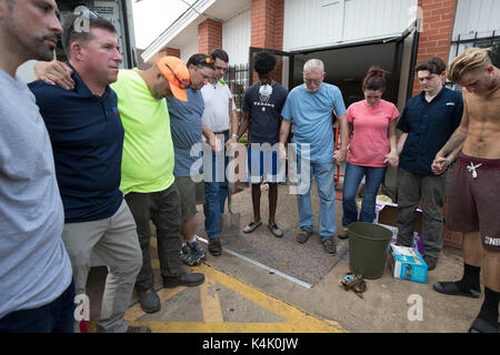 Beaumont, texas usa sept. 5, 2017: Congregazione dei membri e volontari unirsi in preghiera fuori magnolia missionario della chiesa battista dopo la pulizia delle strutture allagata nel Centro Beaumont. La regione sta ancora lottando per recuperare dall uragano harvey quasi due settimane fa. Credito: bob daemmrich/alamy live news Foto Stock