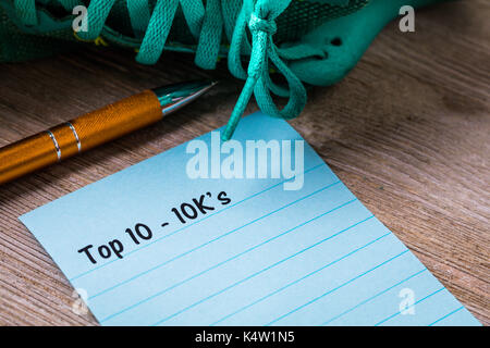 10k correre a piedi concetto su notebook e la tavola di legno Foto Stock