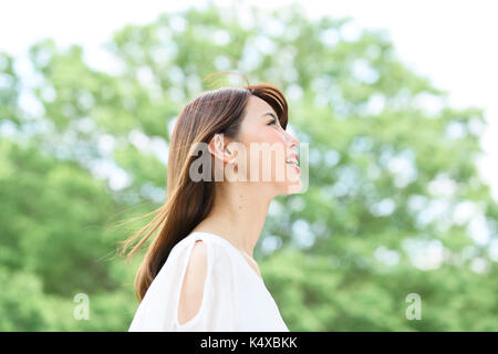 Giovane donna giapponese in un parco della città Foto Stock