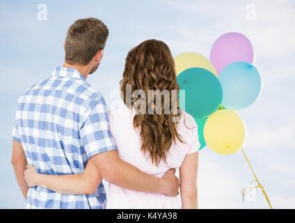 Composito Digitale del retro del giovane guardando palloncini Foto Stock
