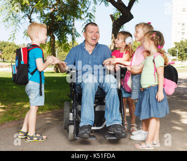 Padre disabili con bambini che mostra l'unità Foto Stock