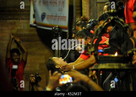 Kathmandu, Nepal. 07Th Sep, 2017. nepalesi per giovani donne e donna locale di bere birra di riso si riversa fuori dalla bocca della maschera enorme di idolo swet bharab il quinto giorno di Indra jatra festival celebrato a basantapur Durbar Square, Kathmandu, Nepal giovedì, 07 settembre 2017. i devoti ha celebrato il dio della pioggia 'indra' per 8 giorni a Kathmandu. la grande maschera di swet bhairab è aperta solo per una settimana durante la Indra jatra festival. devoti ha celebrato il dio della pioggia 'indra' per una settimana a Kathmandu. Credito: narayan maharjan/Pacific press/alamy live news Foto Stock