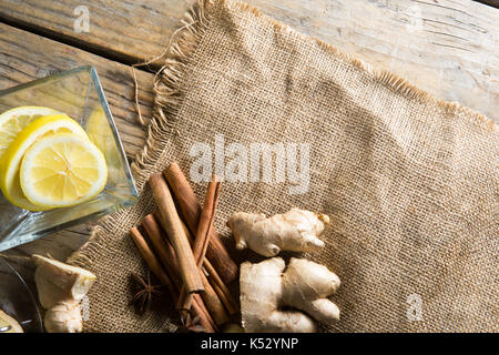 Angolo di alta vista di zenzero e cinnamons su tela da limoni sopra il tavolo Foto Stock