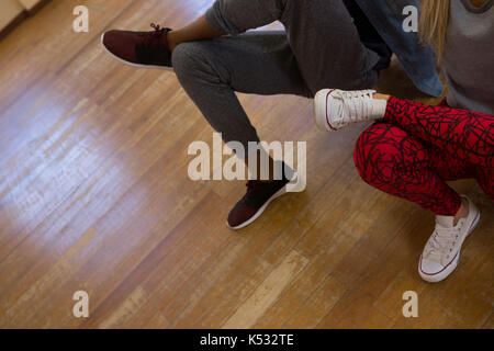 Sezione bassa di ballerini ripassando sul piano di studio Foto Stock