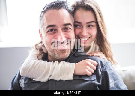 Adolescente ragazza seduta sulla finestra con il padre Foto Stock