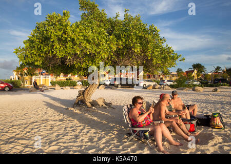 Eagle beach, Aruba - 15 marzo 2017: vista di Eagle beach, aruba al tramonto con divi divi tree e turisti. Foto Stock