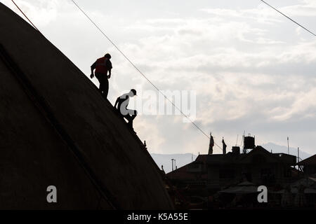 Kathmandu, Nepal - 9/23/2015: operai discendere lo Stupa Boudhanath durante il post terremoto di riparazioni in Kathmandu, Nepal. Foto Stock