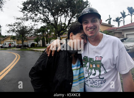 Miramar, fl, Stati Uniti d'America. Decimo Sep, 2017. I vigneti in laghi monarch presidente felix carballo abbracci la moglie Cristina, in rilievo dopo l uragano irma incollato e che hanno visto la loro casa e la comunità è stata risparmiata la vita a notevoli danni diversi da abbattere alberi, le filiali e le cassette postali in occidente miramar comunità domenica. ''Non appena ho potuto uscire mi è venuto e ha iniziato a cancellazione di scarichi per impedire allagamento, '' detto carballo. '' Grazie a Dio non abbiamo fatto grandi danni. Credito: sun-sentinel/zuma filo/alamy live news Foto Stock