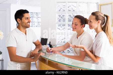 Positivo giovane colloqui con la bellezza degli infermieri in ufficio medico Foto Stock