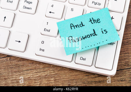 E la password è il testo su una nota adesiva. con il bianco della tastiera del computer. Foto Stock