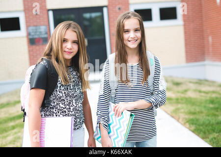 Ritratto di due pre ragazze adolescenti studiano all'aperto nel cortile della scuola Foto Stock