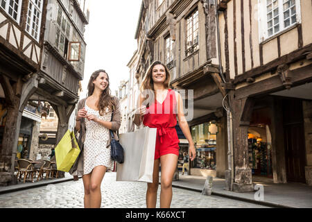 Donne caucasici il trasporto delle borse della spesa in città Foto Stock