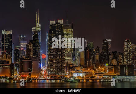 La Super Luna sorge su 42nd Street a Manhattan per fare il corso sullo skyline di New York. Foto Stock