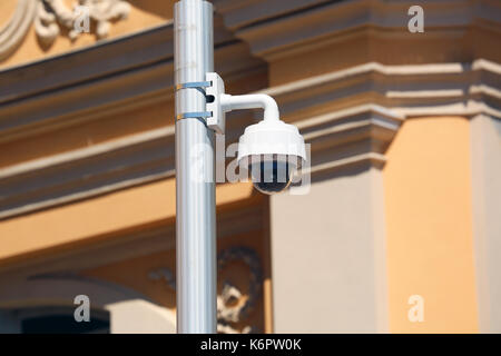 Dome per esterni di tipo telecamera TVCC su strada lampada a Nizza, architettura di una chiesa in background Foto Stock