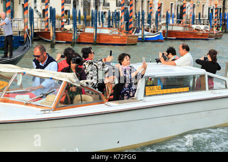 I turisti cinesi su un acqua taxi tour a Venezia. Foto Stock