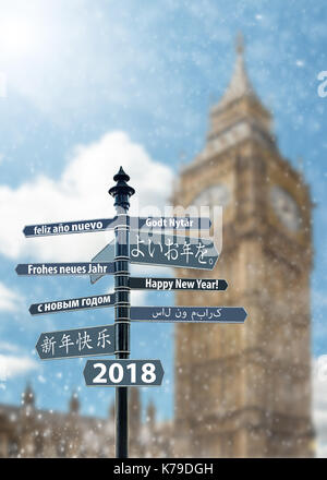 Whit signpost felice anno nuovo in molte lingue, big ben clock tower in background Foto Stock