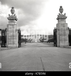 Degli anni Cinquanta, foto storiche dei cancelli e ingresso al parco e della tenuta di Stormont, Belfast, Irlanda del Nord, con il grande edificio alla fine del lungo viale di ingresso progettato in un greco in stile classico, la casa dell'Assemblea dell'Irlanda del Nord (Parlamento) dal 1998. Foto Stock