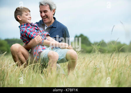 Nonno e nipote di ridere insieme all'aperto Foto Stock