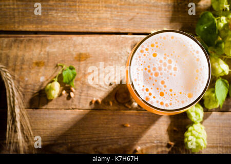 Vista dall'alto su una pinta di birra con gli ingredienti per la birra fatta in casa. Foto Stock