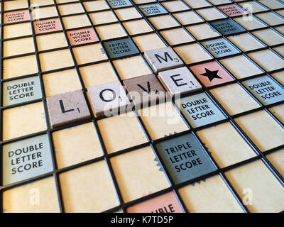 Le parole "love me' enunciato su un gioco SCRABBLE board Foto Stock