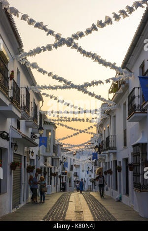 Street in bianco al villaggio spagnolo, Mijas Mijas Pueblo, durante le feste, ghirlande, Andalusia, Spagna. Foto Stock