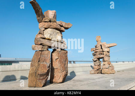 Due granito inukshuk sculture in aria pone di marshalling all'Aeroporto Pearson di Toronto Ontario Canada Foto Stock