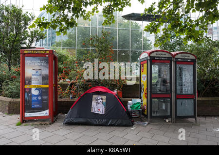 Senzatetto tenda si accamparono tra due telefoni pubblici da Euston Square station, Londra Foto Stock