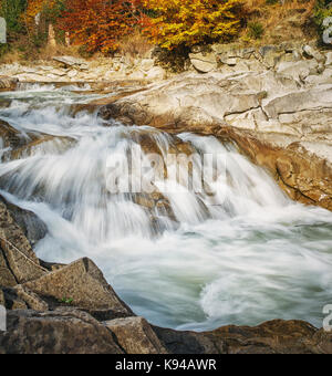 Il paesaggio del fiume di montagna nella foresta di autunno. vista la sassosa rapids. Foto Stock