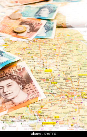 L'Europa. Mappa della Gran Bretagna con British £10 e 5 sterline in banconote e monete metalliche in alto. Foto Stock
