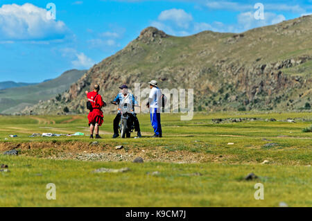 Motor-biker chiedendo a due uomini per la direzione nella steppa, orkhon valley, Khangai Nuruu national park, oevoerkhangai aimag provincia, Mongolia Foto Stock