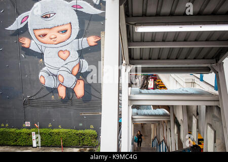 Murale e accesso al passaggio sopraelevato della stazione dello Stadio Nazionale del treno sopraelevato BTS, Bangkok, Thailandia Foto Stock