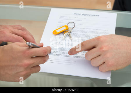 Close-up di una persona che firma il contratto di locazione Foto Stock