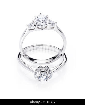 Due diamond impegno gli anelli di nozze isolato su sfondo bianco con la riflessione della luce, un anello in piedi, un anello che stabilisce Foto Stock