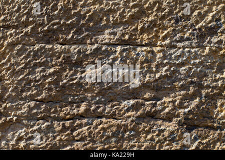 Weathered antico muro di pietra, sfondo texture Foto Stock