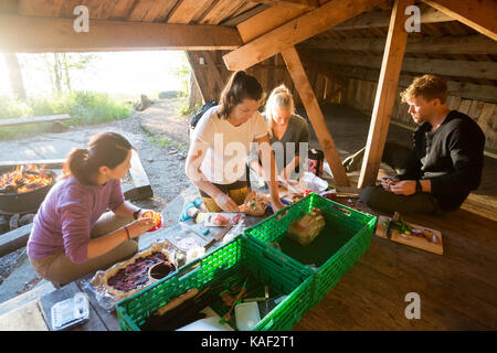 I colleghi nella preparazione degli alimenti in un capannone a forest Foto Stock