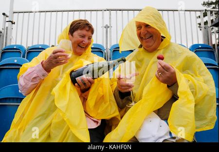 Spettatori riparo dalla pioggia a Eastbourne Tennis Foto Stock