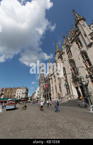Città di Bruges, Belgio. bruges piazza del mercato, con il tribunale provinciale edificio (ex waterhall) in primo piano. Foto Stock