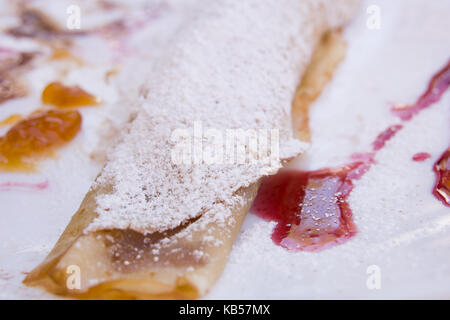 Dettaglio del pancake ripiegata con zucchero e salsa di frutta Foto Stock