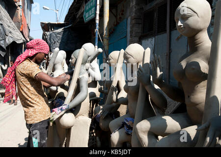 Scultore divinità di finitura, realizzata utilizzando argilla sulla base di paglia in kumartuli vasai trimestre, Kolkata (Calcutta), INDIA Foto Stock