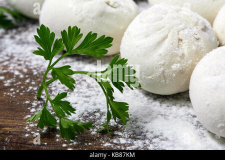 Khinkali sul piatto di legno con farina. pelmeni. Foto Stock