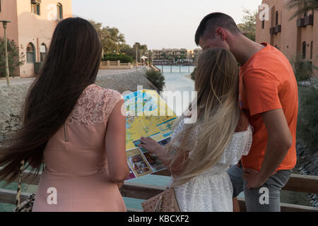 I turisti con mappa ricerca la città sul tramonto. Foto Stock